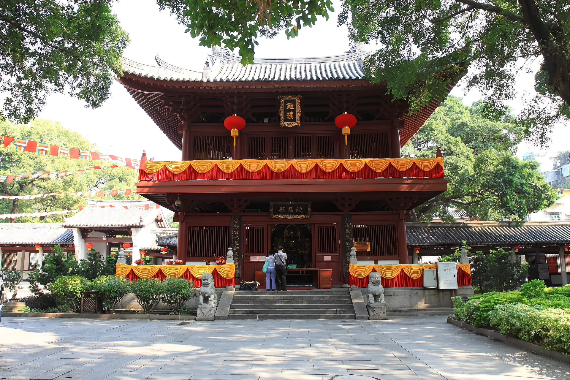 The great hall of Guangxiao Temple with red columns and banners, Guangzhou