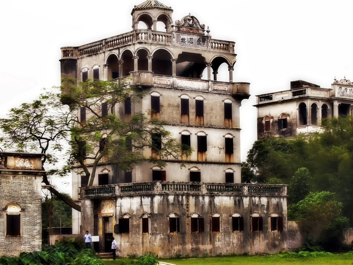 The Inscribed Stone Tower, Mingshi Lou: a five-storey tower with arcaded verandas standing beside a lotus pond