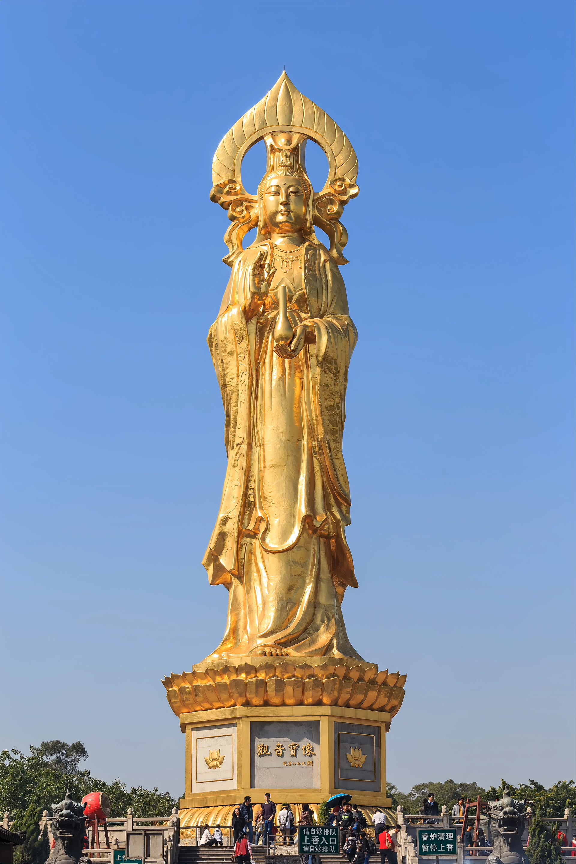 The Gilded bronze Guanyin statue standing above the lotus ponds at Lianhuashan, Panyu