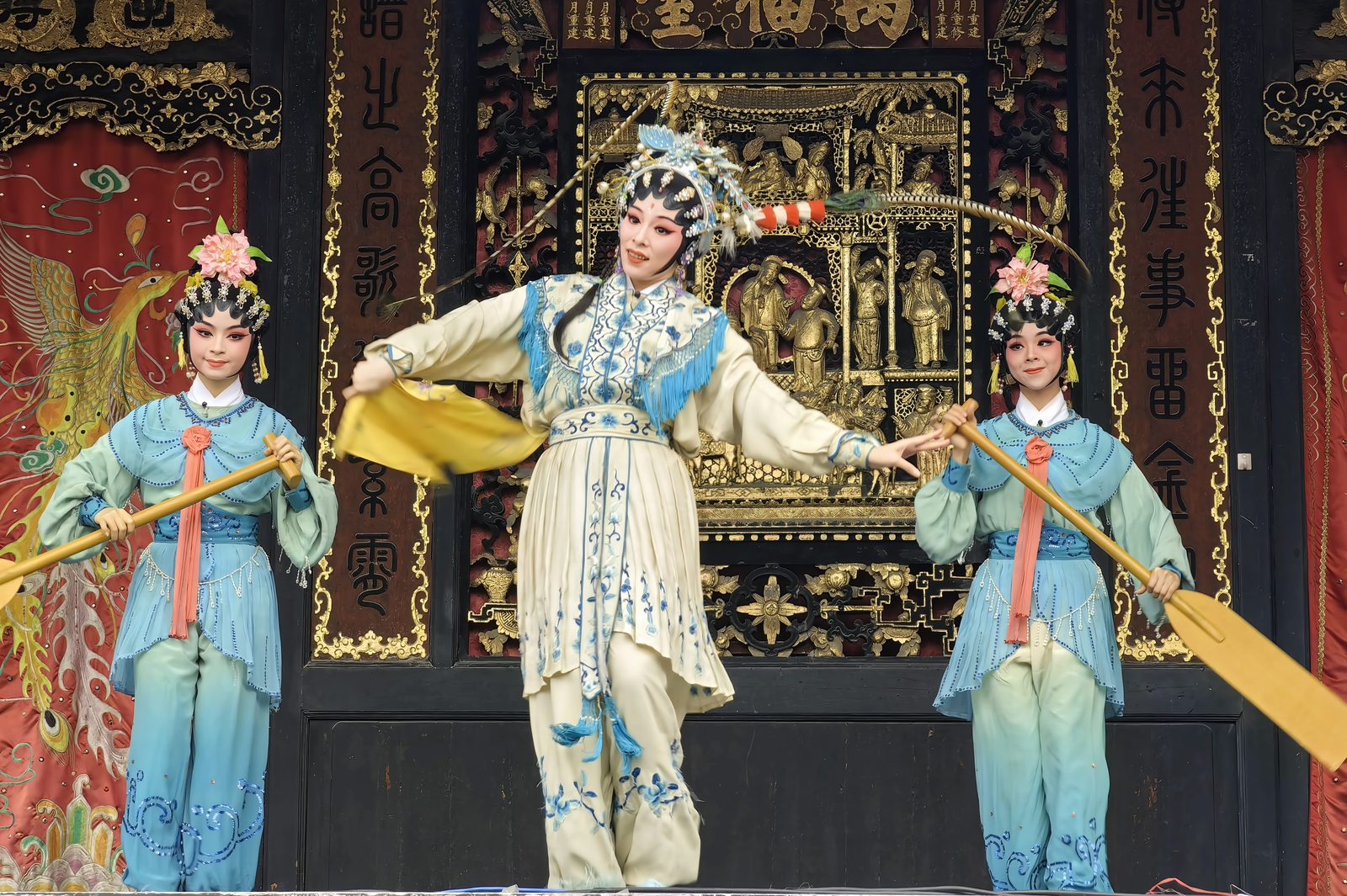 Cantonese opera performers in pale blue and white costume playing a scene on the Wanfu Stage